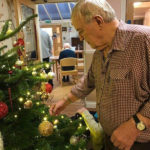 Residents decorating their chosen real Christmas tree at Cedar Lodge