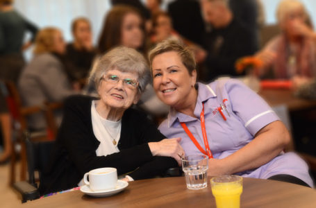 Resident smiling with care assistant at Casa di Lusso Dementia Nursing Home Bridgwater Somerset