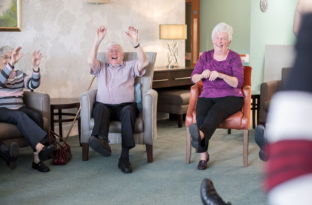 Residents laughing during chair exercise at Casa di Lusso Care home Bridgwater