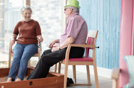 Residents putting their feet in the sand pit in the sun room at Casa di Lusso care home Bridgwater