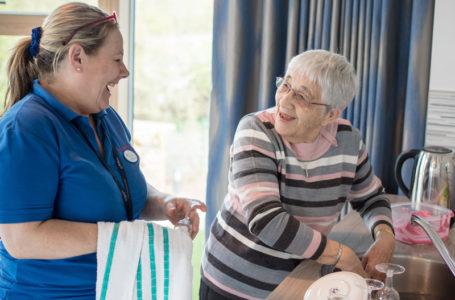 Activities coordinator and resident washing up at Casa di Lusso Care home Bridgwater