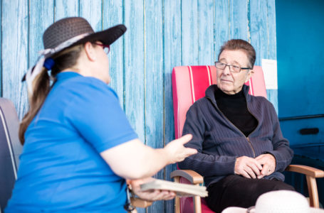 Activities Assistant chatting with resident in the Sun Room at Casa di Lusso Care Home Bridgwater Somerset