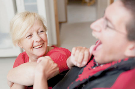 Care Assistant laughing with resident