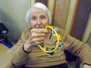 Resident with yellow tambourine