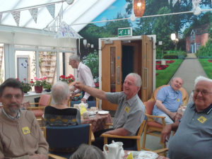 Residents and relatives enjoying afternoon tea in the conservatory