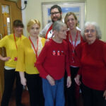 Residents and staff wearing red or yellow for Dementia Awareness Week