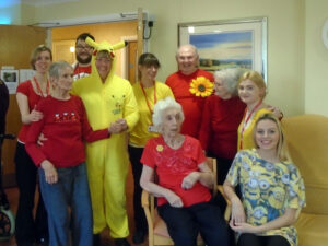 Residents and staff wearing red or yellow