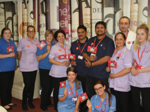 Aspen Court Staff team waving their flags
