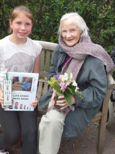 Resident with Curry Rivel pupil presenting her Life Story book and flowers