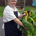 Chef holding up their home grown chard at Immacolata House Dementia Nursing Home Langport