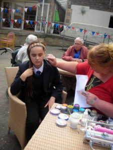 School pupil getting her face painted