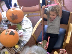 Resident and Little pips, Brooke, decorating a butterfly with ribbons