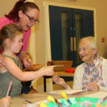One of children painted a picture for resident, Georgie, and presented it to her