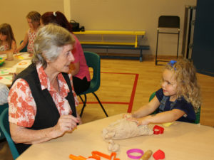 Pam and one of the children getting creative with the playdough