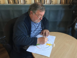 Campania resident colouring in the design for their cake