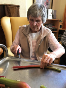 Cedar Lodge resident cutting up rhubarb