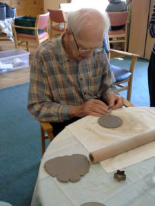 Resident making his clay cake