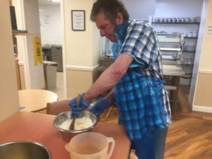 Campania resident mixing the cake mix