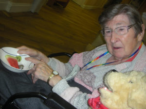 Clarence Park resident tasting and choosing what fruits to have in their cake