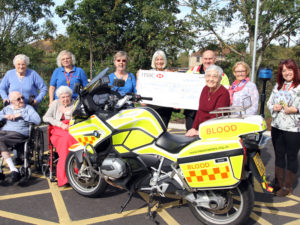 Casa di Lusso residents, staff, Sharon Warren, Ladies from the Firecrackers and Richard from Freewheelers holding the big cheque