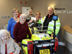 Florence (Casa di Lusso resident) with Ladies from Firecrackers presenting cheque to Richard from freewheelers