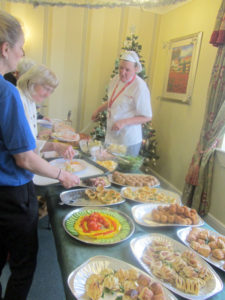 Immacolata House residents and loved ones at buffet lunch table
