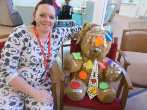 La Fontana staff member in her pajamas with their teddy bear