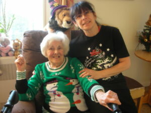 Resident with staff member wearing Christmas Jumper and Tshirt