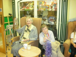 Residents with tinsel pom poms