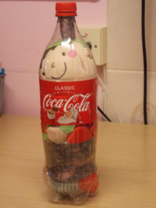 Elf stuffed in a Coca cola bottle