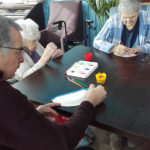 Residents decorating their paper plate fans