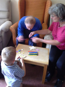 Little Pips and resident doing arts and crafts together at Immacolata House Dementia Nursing Home Langport
