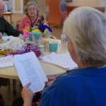 Gillian Stephens, activities coordinator, reading 'dignity' poems with residents and loved ones