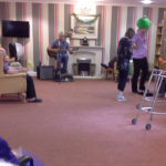 Staff and residents having fun on National Smile Day with Chris Clarke's live music