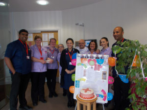 La Fontana Nurses with their care team behind the International Nurses Day display board, decorations and their home made celebratory cake