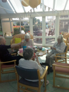 residents knitting baby blankets at their knit n natter club, Immacolata House Dementia Care Home, Langport
