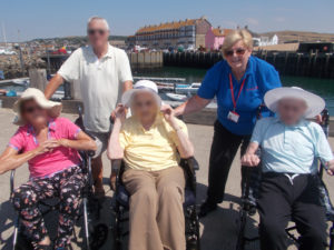 La Fontana Dementia Nursing Home residents and activities assistant a the harbour in Westbay Dorset
