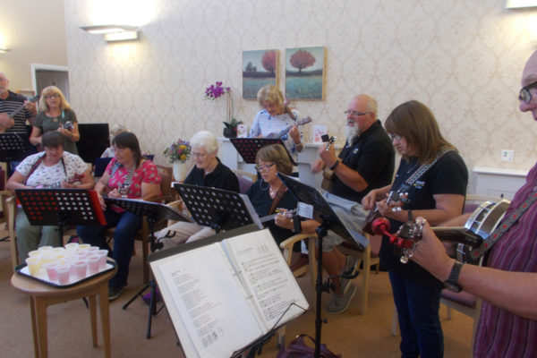 The Yeovil Ukulele Club entertaining residents and loved ones at La Fontana during their August Activities