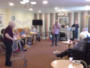 Immacolata House care home resident dancing and singing along with John and The General