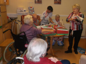 Residents and staff at Clarence Park Nursing Home decorating their shoe boxes ready to fill with gifts for the children