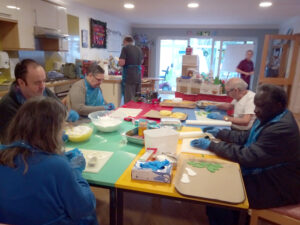 Residents at Serenita ARBD care home, rolling and cutting out icing decorations for their Christmas Cake