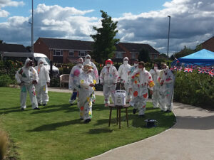 Casa di Lusso staff members in the costumes made by the residents for their social distancing garden party